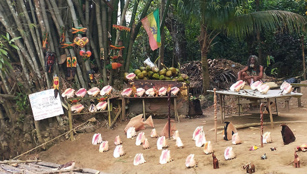 A vendor sells his wares along the river.