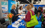 Attendees stopped by the Pearl Seas Cruises booth, one of the 170 companies to exhibit at the Exhibitor Showcase.