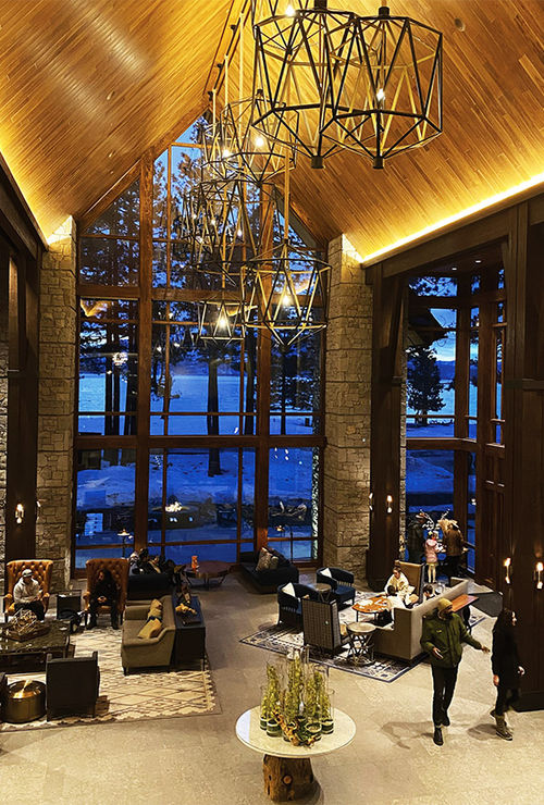 Board game hour at the resort's Lodge Great Room, with views of the sun setting on the lake.