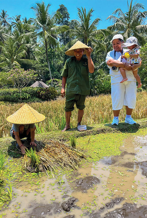 Christina Jelski's children with Wirawan and Sari, who served as guides during the "A Day in the Life of a Balinese Farmer" excursion.