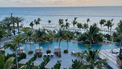 The pool deck of the Waldorf Astoria Cancun is peppered with palm trees and offers some gorgeous sea views.